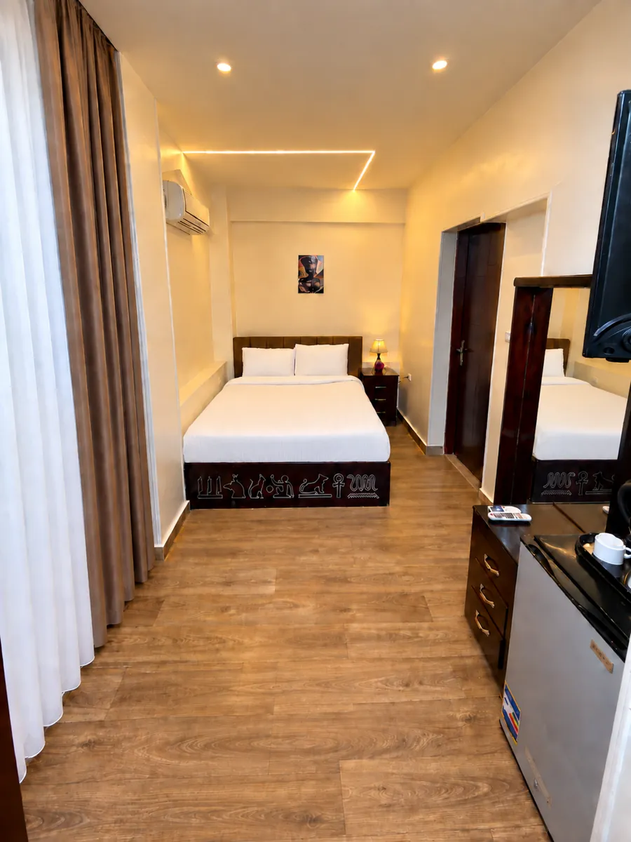 Room 201 with double bed and warm lighting
