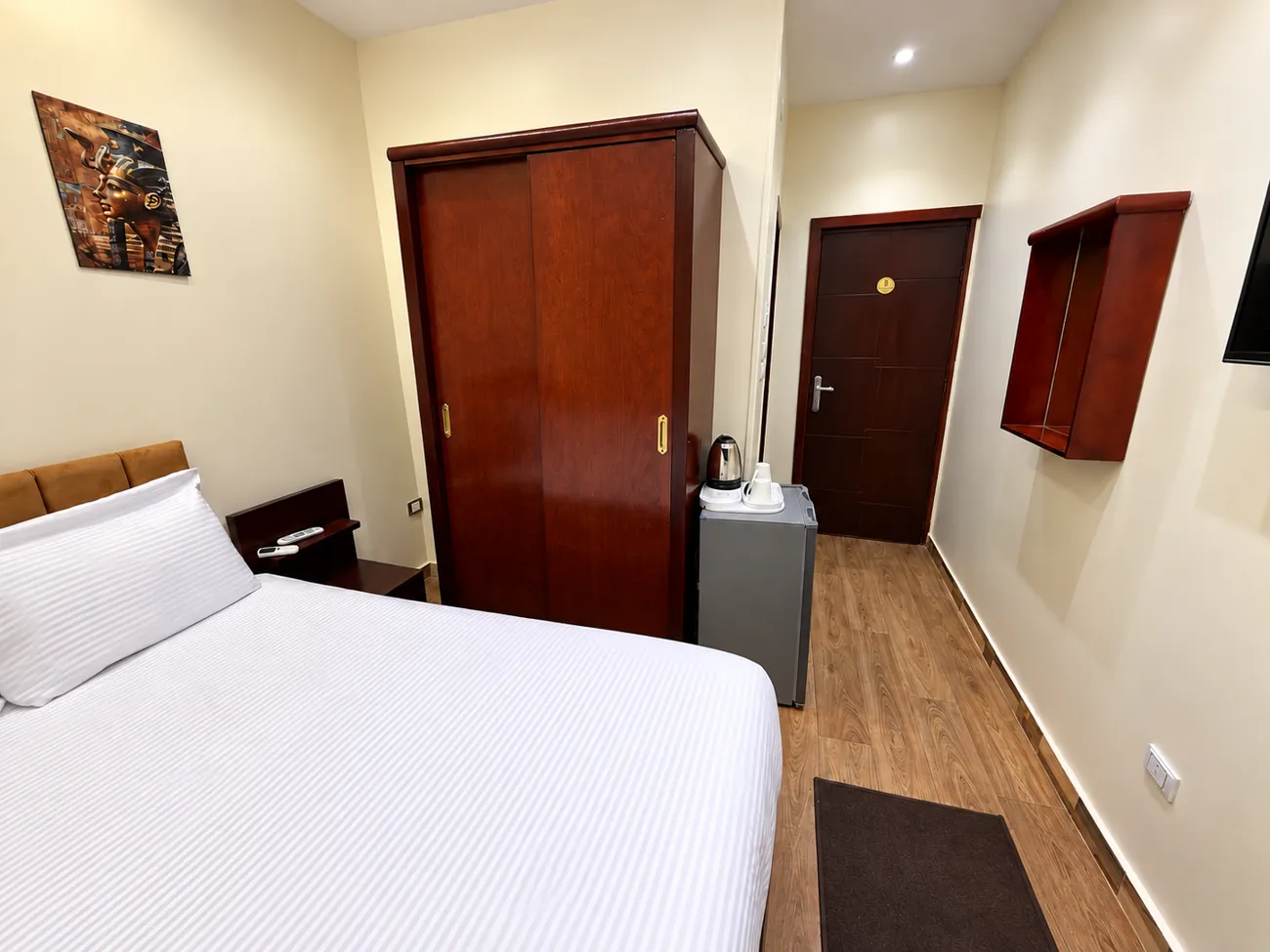 Room 203 with sliding wardrobe, refrigerator, electric kettle and the entrance door